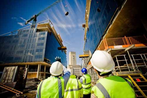 Maintenance Men rappel down a building